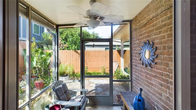 unfurnished sunroom with a ceiling fan