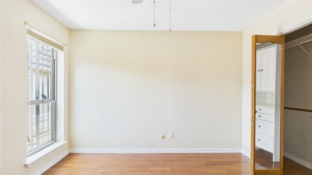2026 Ashford Hollow Ln, Houston, TX 77077 - unfurnished bedroom featuring light wood-style flooring, baseboards, and ceiling fan