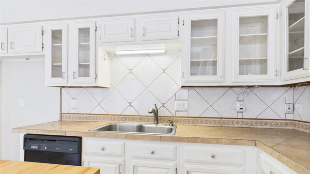 2026 Ashford Hollow Ln, Houston, TX 77077 - kitchen with black dishwasher, a sink, light countertops, and white cabinetry