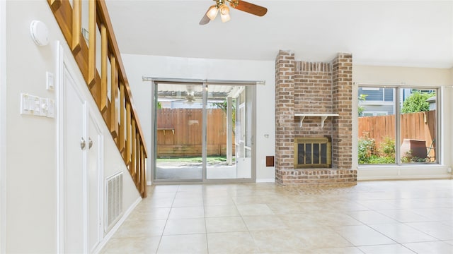 2026 Ashford Hollow Ln, Houston, TX 77077 - unfurnished living room with ceiling fan, tile patterned flooring, and a fireplace