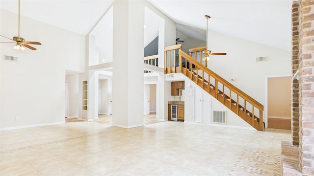 2026 Ashford Hollow Ln, Houston, TX 77077 - unfurnished living room with ceiling fan, high vaulted ceiling, stairs, and wine cooler