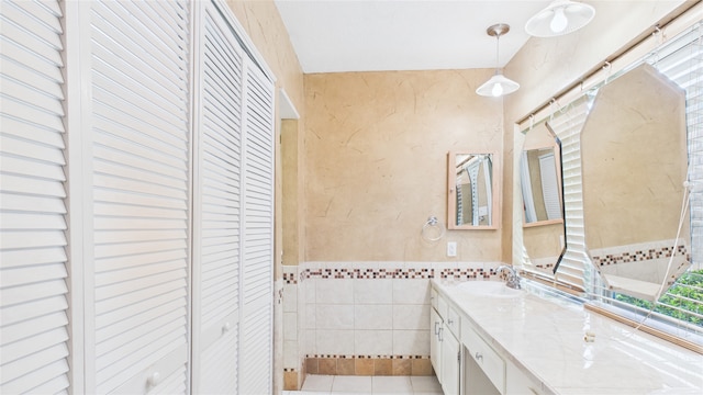 2026 Ashford Hollow Ln, Houston, TX 77077 - bathroom with a closet, tile walls, vanity, tile patterned flooring, and wainscoting