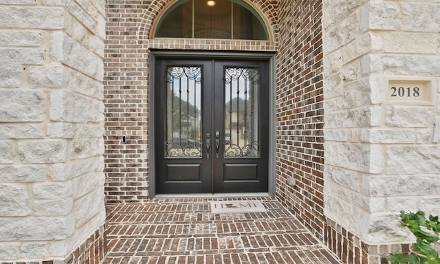 property entrance with french doors and brick siding