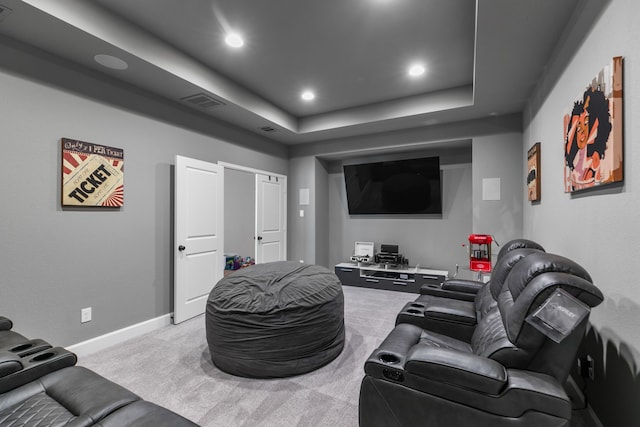 home theater with recessed lighting, a tray ceiling, carpet floors, and baseboards