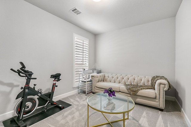 carpeted living area with baseboards and visible vents