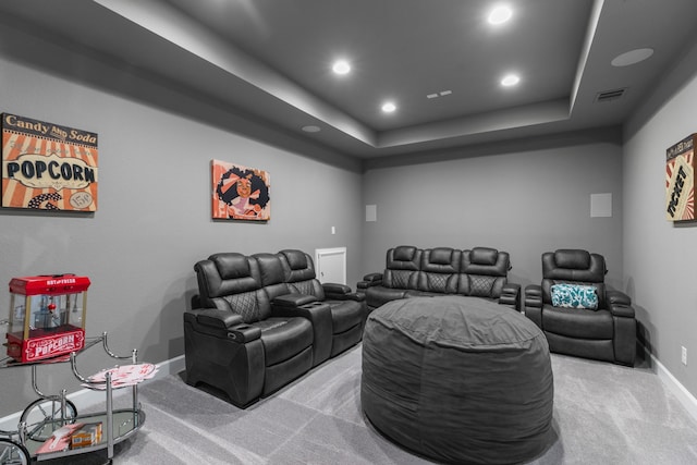 home theater room with visible vents, a tray ceiling, recessed lighting, carpet flooring, and baseboards