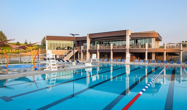 pool with stairs, a patio area, and fence