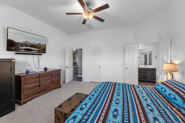 carpeted bedroom with visible vents, connected bathroom, attic access, and ceiling fan