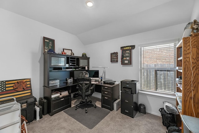 carpeted office space with baseboards and vaulted ceiling