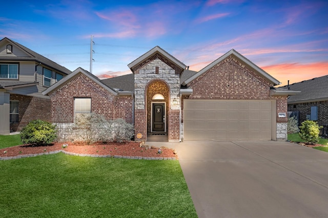 view of front facade featuring a front lawn, stone siding, concrete driveway, an attached garage, and brick siding