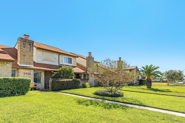 view of front of property with a front lawn and a chimney