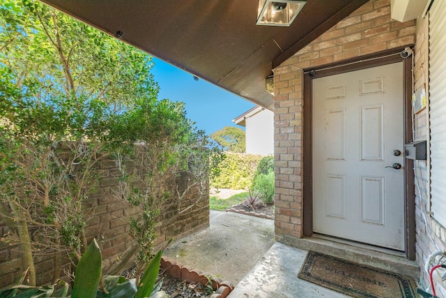 entrance to property with brick siding