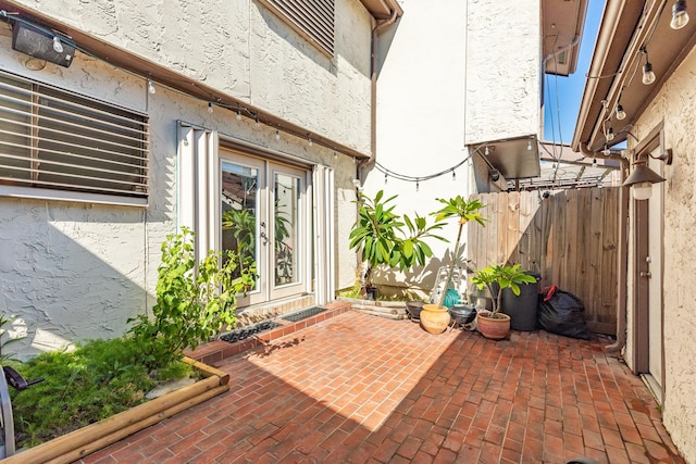 view of patio / terrace featuring french doors and fence