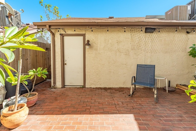 view of patio featuring cooling unit and fence