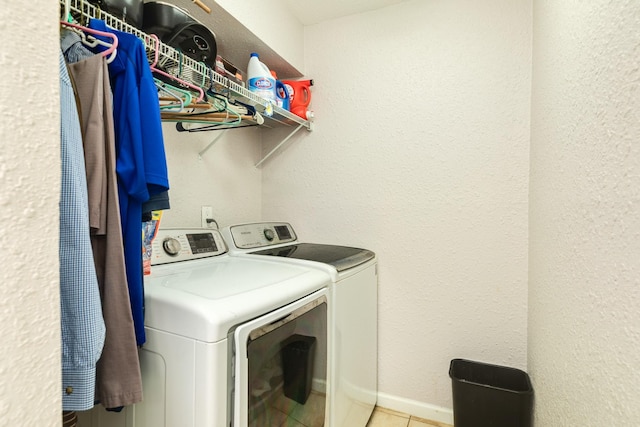 washroom with washing machine and dryer, laundry area, and tile patterned flooring