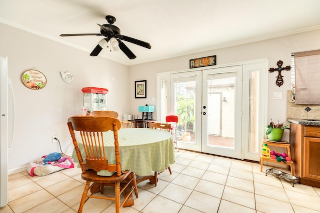 dining space featuring light tile patterned floors, french doors, a ceiling fan, and ornamental molding