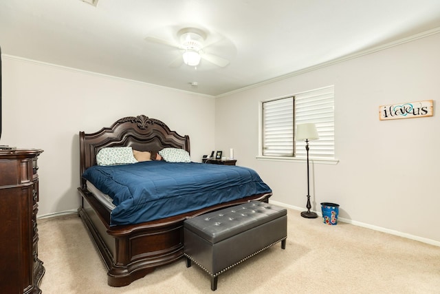 carpeted bedroom with baseboards, ceiling fan, and crown molding