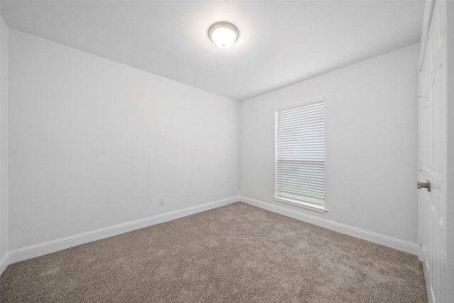 spare room with carpet flooring and baseboards