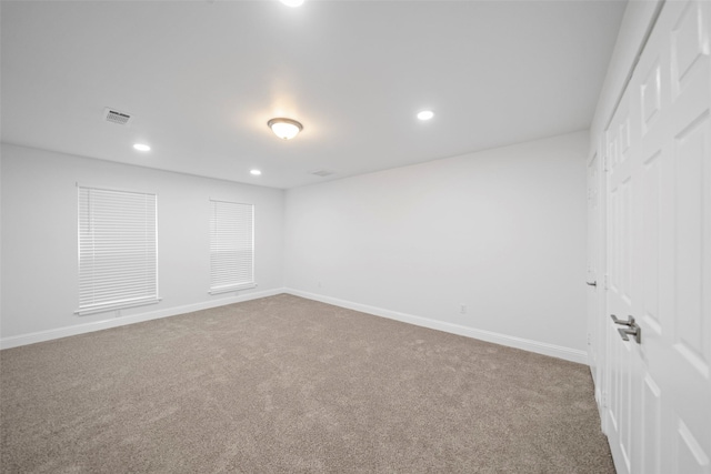 carpeted spare room with recessed lighting, visible vents, and baseboards