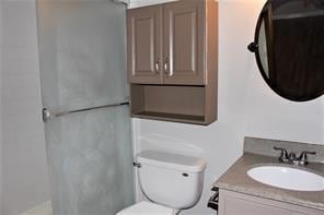 bathroom featuring toilet and vanity