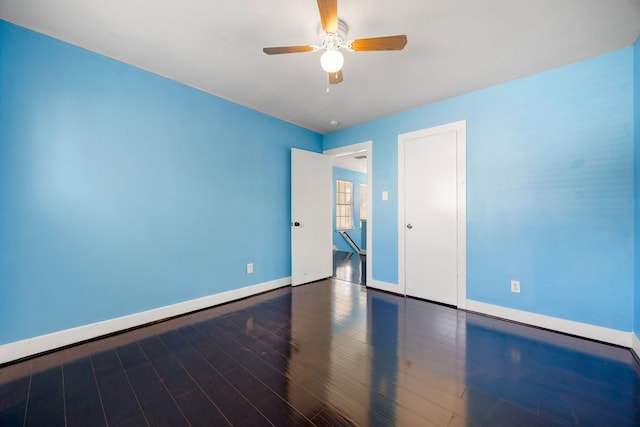 unfurnished bedroom with ceiling fan, baseboards, and wood finished floors