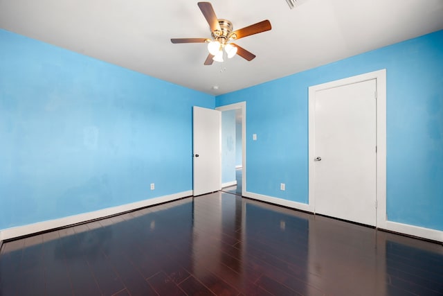 unfurnished bedroom with ceiling fan, baseboards, and wood finished floors