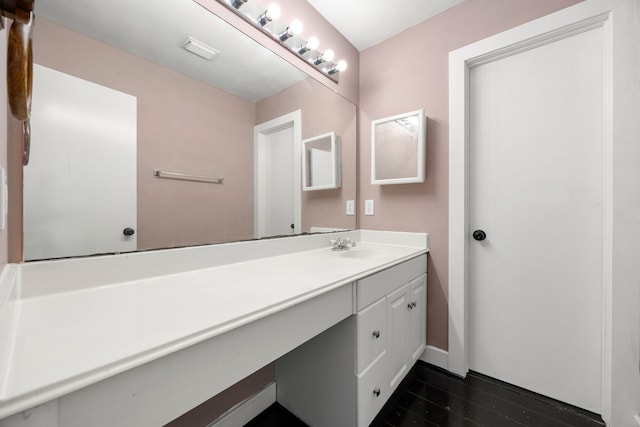 bathroom featuring wood finished floors and vanity