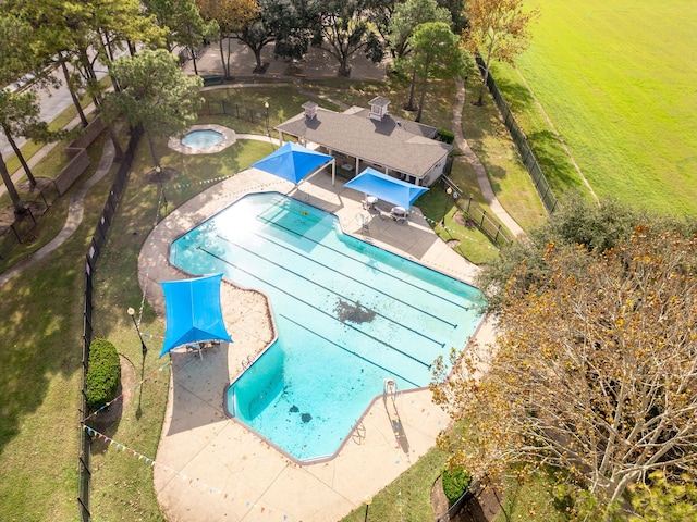 pool with a patio, a fenced backyard, and a hot tub