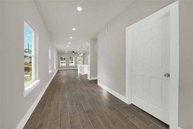 hall featuring a wealth of natural light, baseboards, recessed lighting, and wood tiled floor