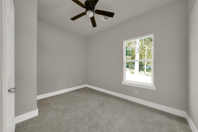 empty room featuring carpet, baseboards, visible vents, and ceiling fan