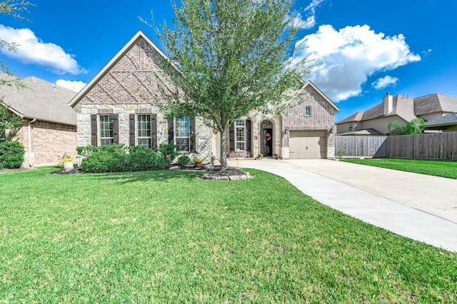 view of front facade with fence, driveway, a front lawn, a garage, and brick siding