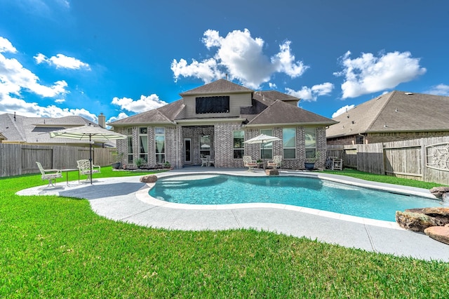 view of swimming pool featuring a patio, a yard, a fenced in pool, and a fenced backyard