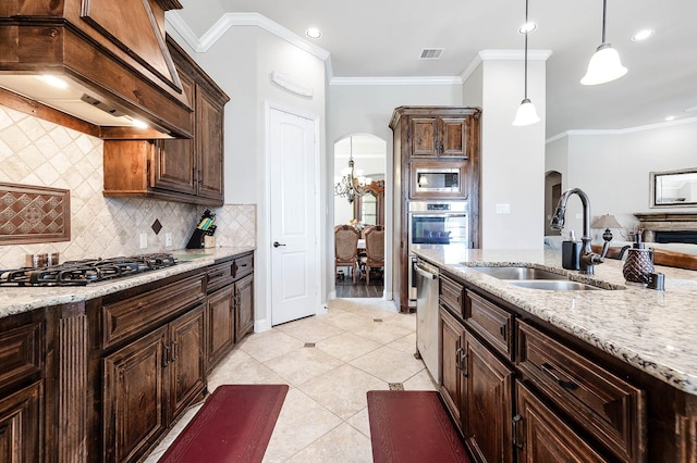 kitchen with visible vents, custom exhaust hood, arched walkways, stainless steel appliances, and a sink