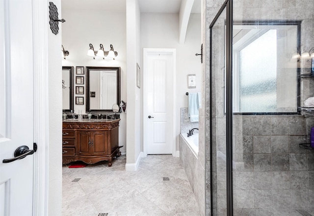 bathroom featuring vanity, a bath, and a shower stall