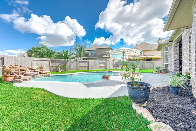 view of swimming pool featuring a yard, a fenced in pool, a fenced backyard, and a patio area