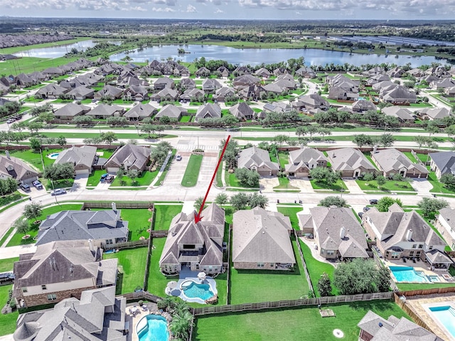 bird's eye view featuring a residential view and a water view