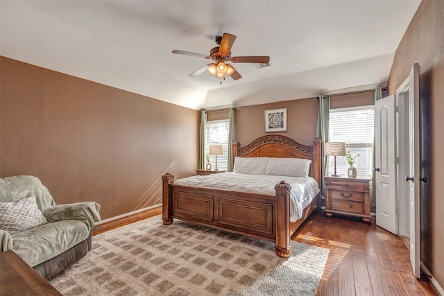 bedroom featuring multiple windows, ceiling fan, lofted ceiling, and hardwood / wood-style flooring