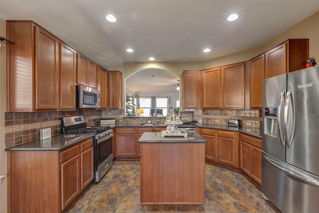 kitchen with a kitchen island, stainless steel appliances, recessed lighting, and a sink