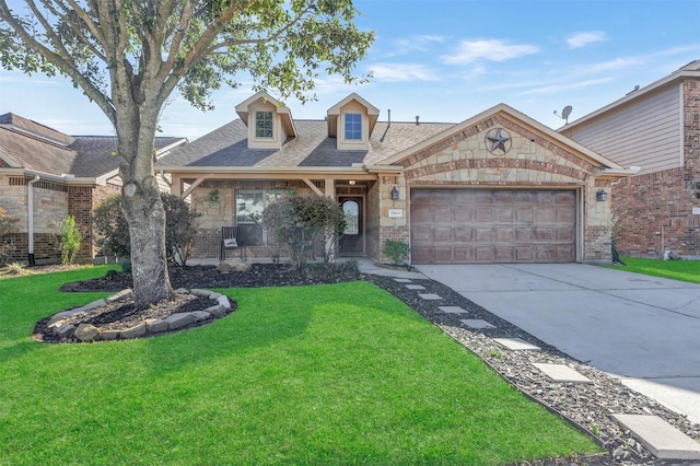 view of front facade with an attached garage, concrete driveway, brick siding, and a front yard