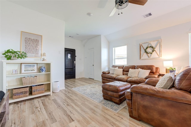 living room featuring visible vents, baseboards, ceiling fan, vaulted ceiling, and wood finished floors