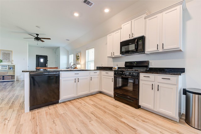 kitchen featuring visible vents, black appliances, open floor plan, white cabinetry, and a peninsula