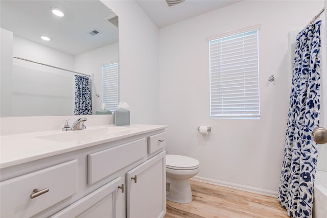 full bathroom featuring vanity, a shower with curtain, wood finished floors, baseboards, and toilet