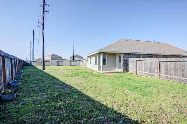 view of yard with a fenced backyard