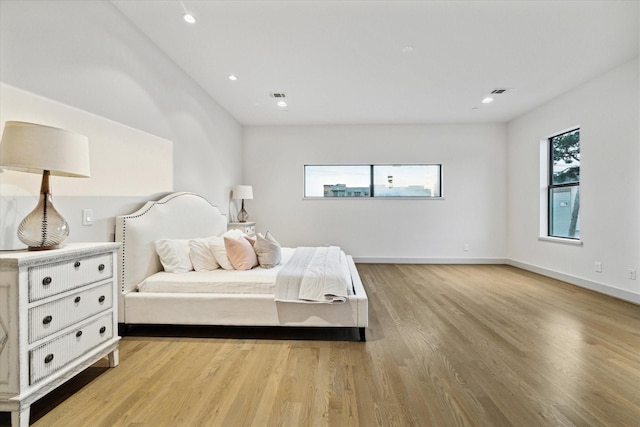 bedroom with recessed lighting, baseboards, visible vents, and light wood finished floors