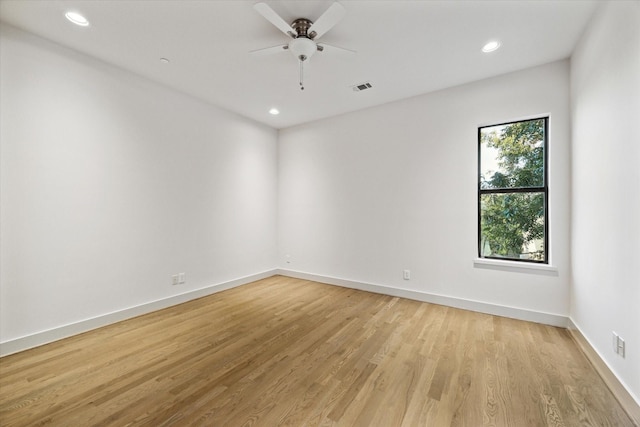 spare room with a ceiling fan, baseboards, visible vents, light wood finished floors, and recessed lighting