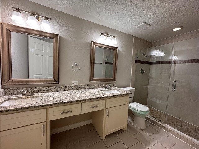 full bath with a shower stall, toilet, visible vents, and a sink