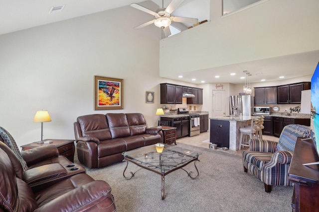 living area featuring recessed lighting, visible vents, a ceiling fan, and a toaster