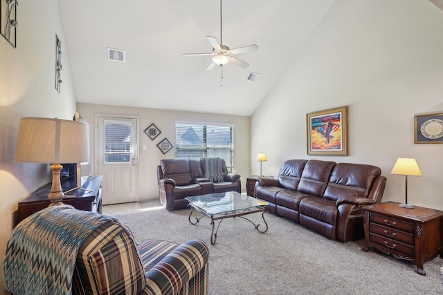 living room featuring high vaulted ceiling, light colored carpet, visible vents, and ceiling fan