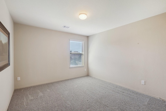 unfurnished room featuring carpet flooring and visible vents