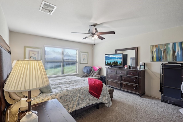 carpeted bedroom featuring visible vents and a ceiling fan